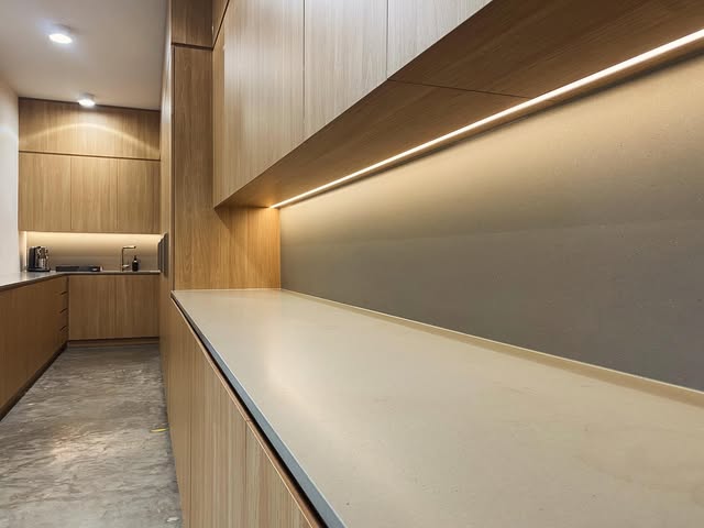 Concealed LED strip lighting above joinery