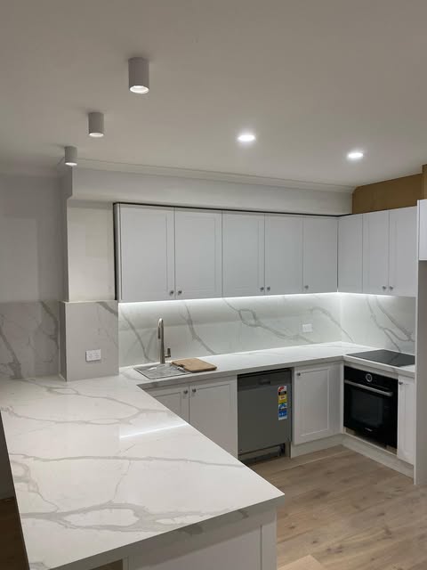 Kitchen with surface mounted downlights and under-cupboard lighting