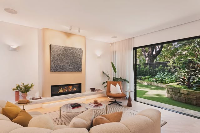 Living room with wall lighting and a garden outlook